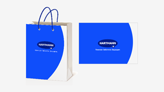 Visualization of how the HARTMANN logo should be placed centrally on different products like paper bags. 
