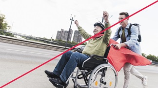  An example of a picture that does not embody the HARTMANN visual language. The picture shows someone in a wheelchair being pushed by a laughing person on a motorway. 