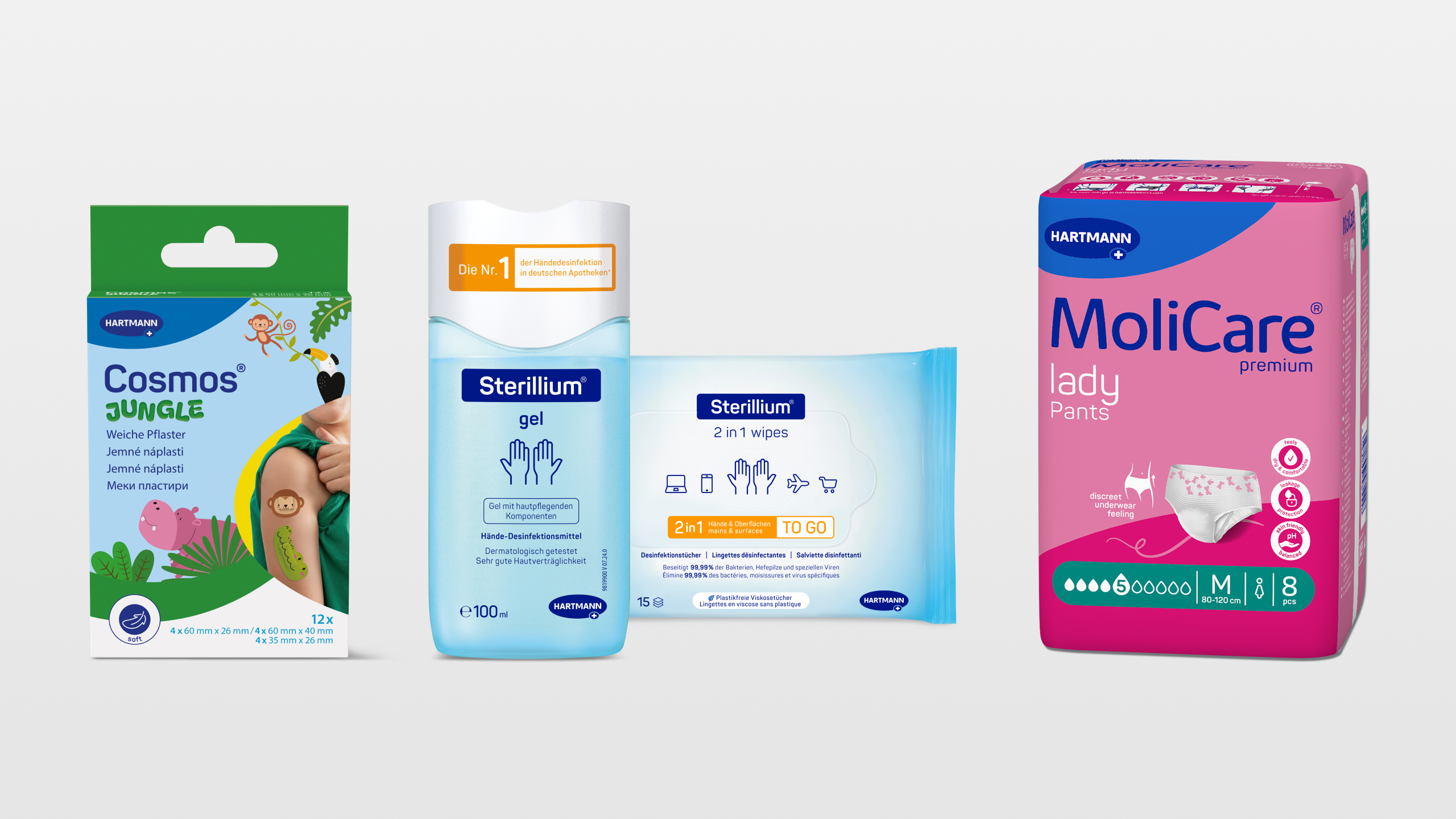 Assorted medical and hygiene products, including wound dressings, hand disinfectant, and incontinence pads.
